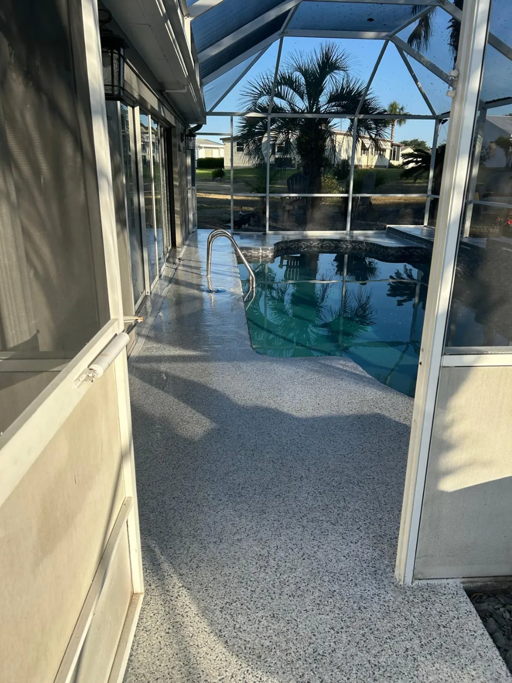 Screened Pool Deck Coating with Handrail by Elite Epoxy Surfaces, Central Florida